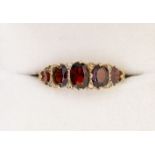 A 9 carat gold five stone garnet ring, size M