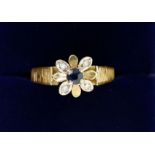 An 18 carat gold diamond and sapphire cluster ring, size M to N