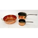 A copper two handled preserving pan and two saucepans