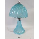 A 1930's blue glass table lamp and shade, 26cm tall