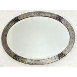 An oval pewter framed mirror, 57 x 42cm
