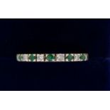 A 9 carat gold eternity ring set emeralds and diamonds, size P to Q