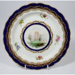 A Royal Worcester plate painted classical ruins within floral, gilt and blue border signed Harry