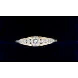 An 18 carat yellow and white gold ring set brilliant cut diamond (approx 1/4 carat) flanked by
