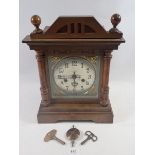 A Victorian oak mantel clock with silvered dial, 35cm tall