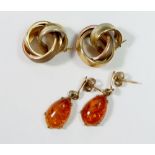 A pair of 9 carat gold triple hoop earrings 5.8g plus a pair of amber and 9 carat gold earrings