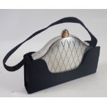 A Volupte handbag form evening vanity case or necessaire with compact, lipstick holder etc.