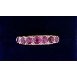 An 18 carat gold seven stone ruby ring (rubies est 1.25 cts) size O