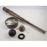 A brass telescope inscribed Broadhurst Clarkson dated 1942, a canon ball, shell fuse and brass