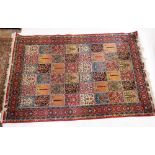 A Persian style wool carpet with floral and foliage decoration 279 x 185cm