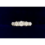 An 18 carat gold and platinum set five stone diamond ring, size O