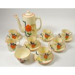 A Wilkinson's Art Deco Honey Glaze coffee set decorated in the style of Clarice Cliff with orange
