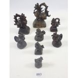 A collection of eight Chinese bronze opium weights in the form of dragons and birds, largest 12cm