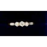 An 18 ct gold three stone diamond ring, size S, 1.8g