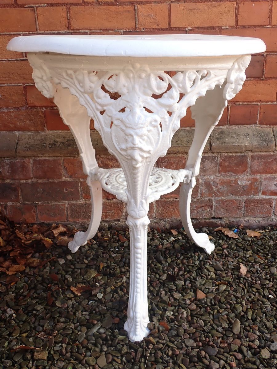 A Victorian cast iron circular bar or garden table with mask decoration and painted wooden top ( - Image 2 of 3