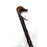 Blackthorn walking stick with carved goose head handle by Theo Fossel, together with another walking