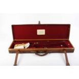 Oak and leather gun case with brass corners, red baize fitted interior for 30 ins barrels, three
