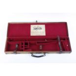 Canvas and leather gun case with remnant period outer labels, red baize lined fitted interior for 30