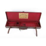 A good leather gun case with red baize lined fitted interior for 30 ins barrels, Harrison & Hussey