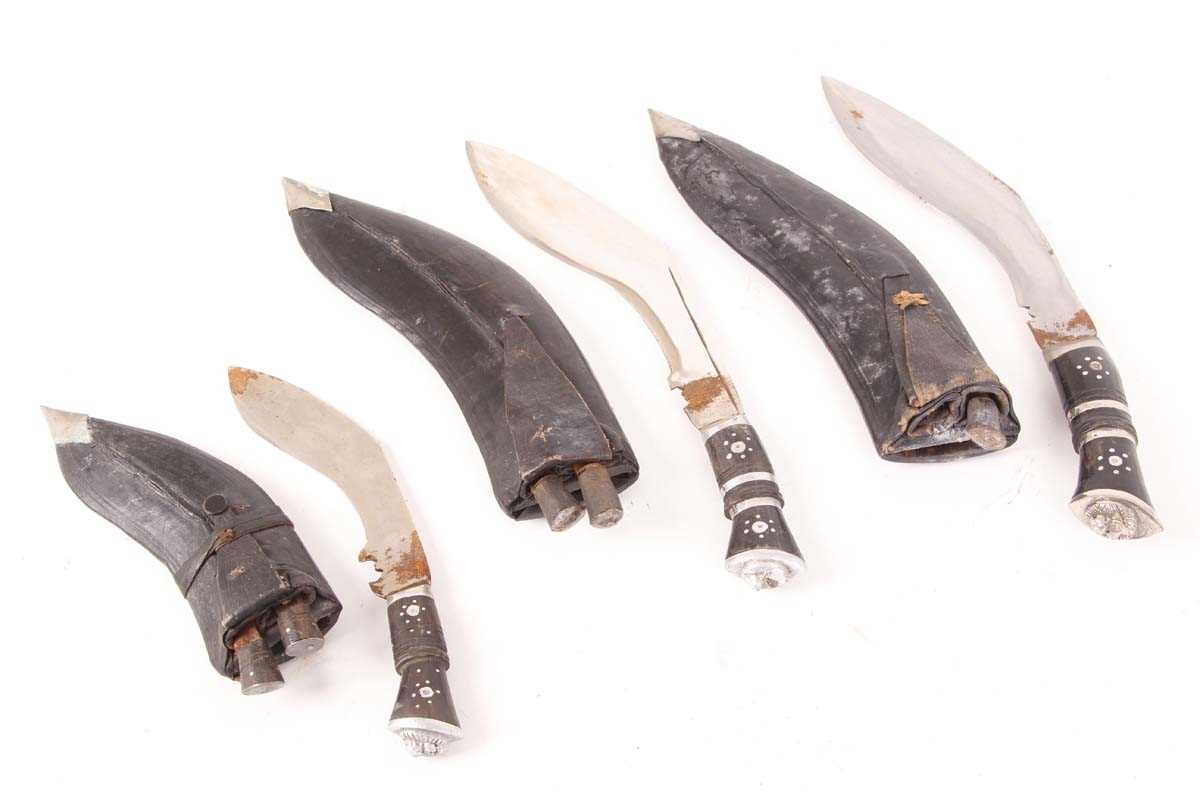 Three Kukri knives: 8½ ins, 9 ins, and 6 ins blades, each with decorative etching to blade and in