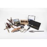 Box containing various collectors knives, digital callipers, digital scales, percussion pistol,