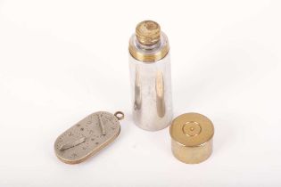 A vintage French game counter, together with a pewter and brass drinking flask in the form of a