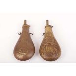 Two brass American powder flasks with embossed decoration and suspension rings