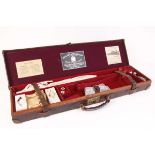 Oak and leather gun case, purple and red baize lined fitted interior for 28 ins barrels, Holland &