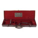 A good leather gun case with claret baize lined fitted interior for 30 ins barrels, W. W. Greener