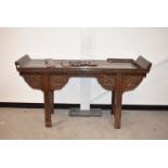 A late 19th Century Chinese Hardwood alter table, 166cm wide by 49cm deep and 90cm high, some