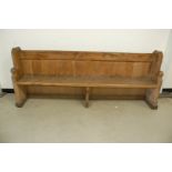 A Victorian heavy oak pew, evidence of woodworm to each end, 232cm wide