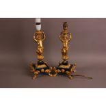 A pair of early 20th century continental figural lamp bases, having gilt figures of young boys on