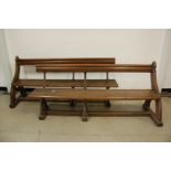 Two Victorian oak pews, on ogee arch supports with wrought iron uprights, both 183cm, probably