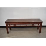 An Oriental hardwood bench, in red, 38cm D x 134cm W,