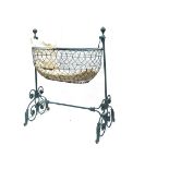 A 19th Century cast-iron and wire swing baby's cradle, with elaborate scrolling stand and brass