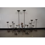 A collection of later 20th Century iron candle holders 102cm H and smaller, (11)