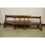 Two Victorian oak and wrought iron pews, on ogee arch supports, 181cm and 183cm, probably once a