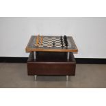 A modern chess topped coffee table, 57cm wide, having magnatised board and pieces to top, with lower