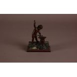 A mid 19th century Italian bronze and marble figure of a cupid forging his arrows, 15cm, some