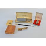 A set of brass sovereign scales, a 19th Century ivory and white metal cigarette case, a satin wood
