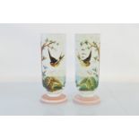 A pair of Victorian opaque glass mantel vases, having hand painted decoration of birds in flight