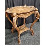 A carved Italian walnut two tier table, having removable twin acanthus moulded handle tray to top,