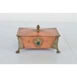 An Arts and Crafts copper and enamel lead lined footed casket, with stylised leaf, bracket