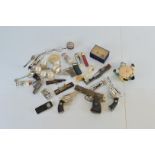 A mixed lot of collectables, including novelty lighters , James Bond themed lighters, silver