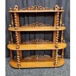 A 19th Century walnut waterfall four tier wall hanging shelf, having barley twist supports and