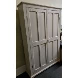 A modern pine sage green painted cabinet, having double doors to five shelf interior with row of