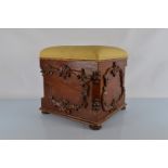 A stained mahogany square lift top upholstered stool or ottoman, having relief moulded scroll and