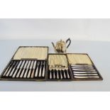 A cased set of six silver handled fruit knives and forks, together with six sterling silver cased