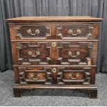 A 19th Century oak chest of drawers, having three long drawers of varying sizes, all with carved and