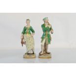 A pair of 19th Century Meissen figurines, modelled as a huntsman and woman, he with horn, she with